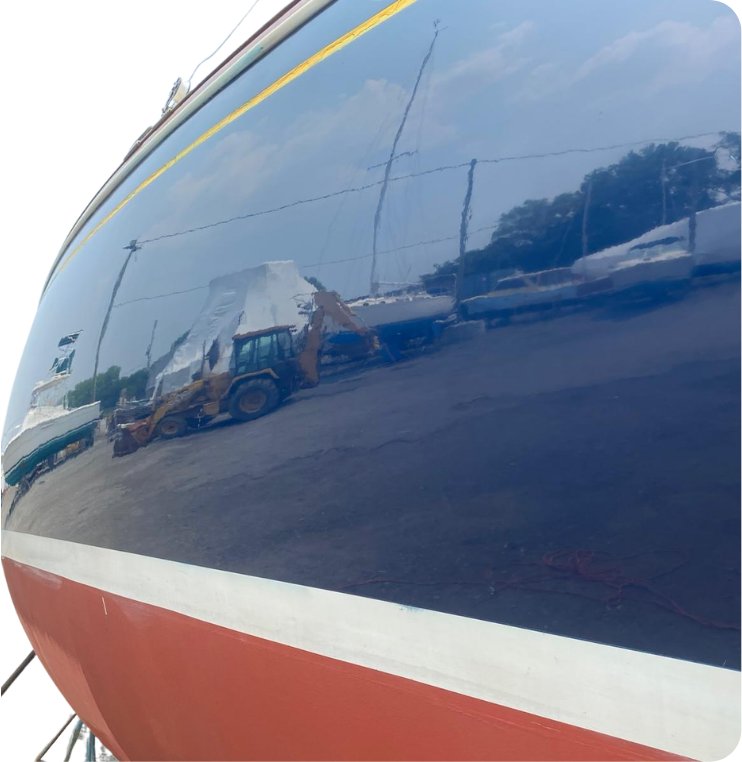 Mirror-finish hull reflecting the marina after gelcoat restoration